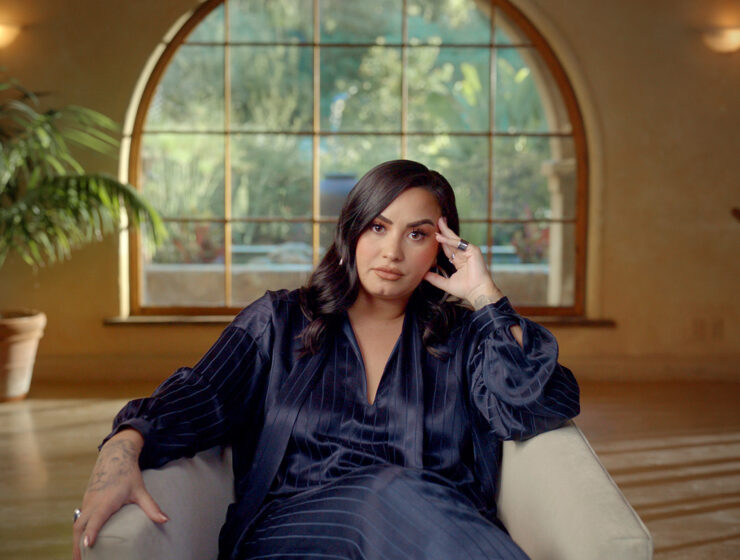 Demi Lovato sat in living room for interview in documentary Demi Lovato: Dancing with the Devil on Youtube