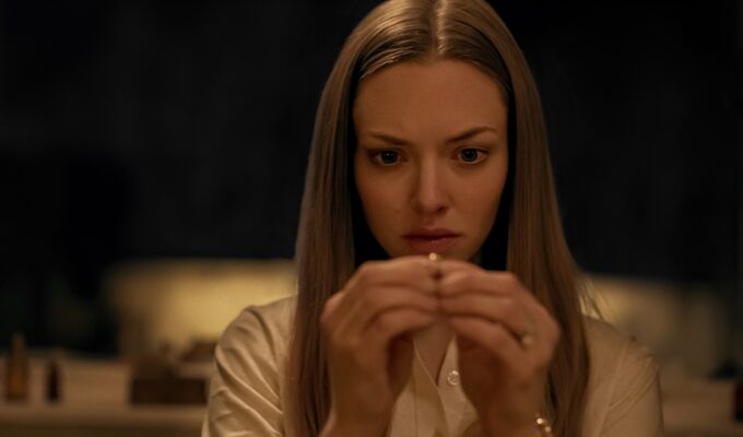 Amanda Seyfried as Claire holding ring in Netflix horror film Things Heard & Seen, 2021