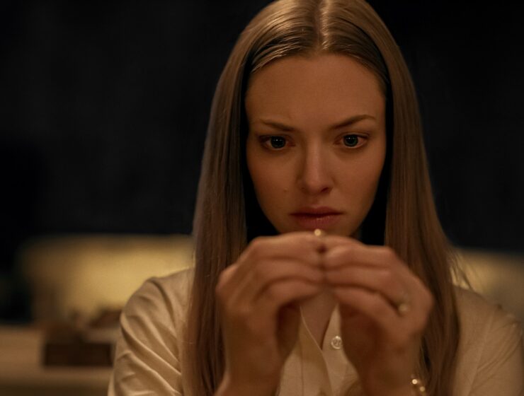 Amanda Seyfried as Claire holding ring in Netflix horror film Things Heard & Seen, 2021