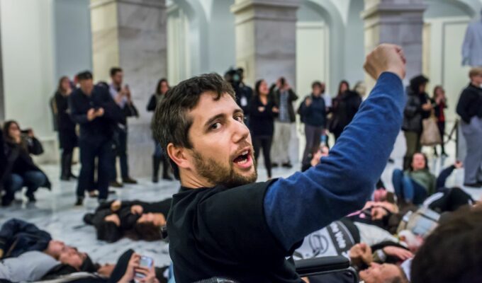 Not Going Quietly documentary by Nicholas Bruckman sees Ady Barkan raising his fist in Capitol Hill