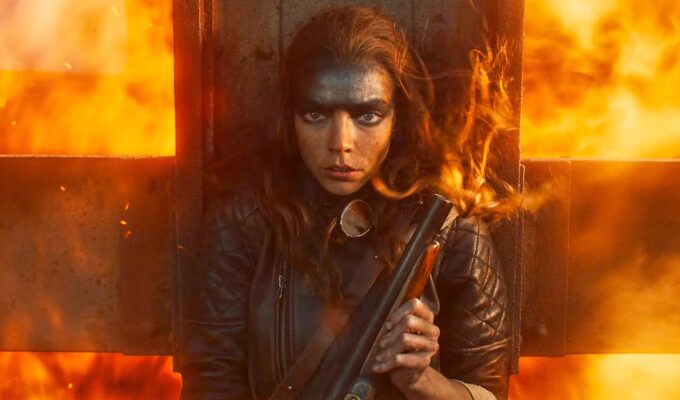 anya taylor-joy as furiosa shielding herself from fire in a mad max saga